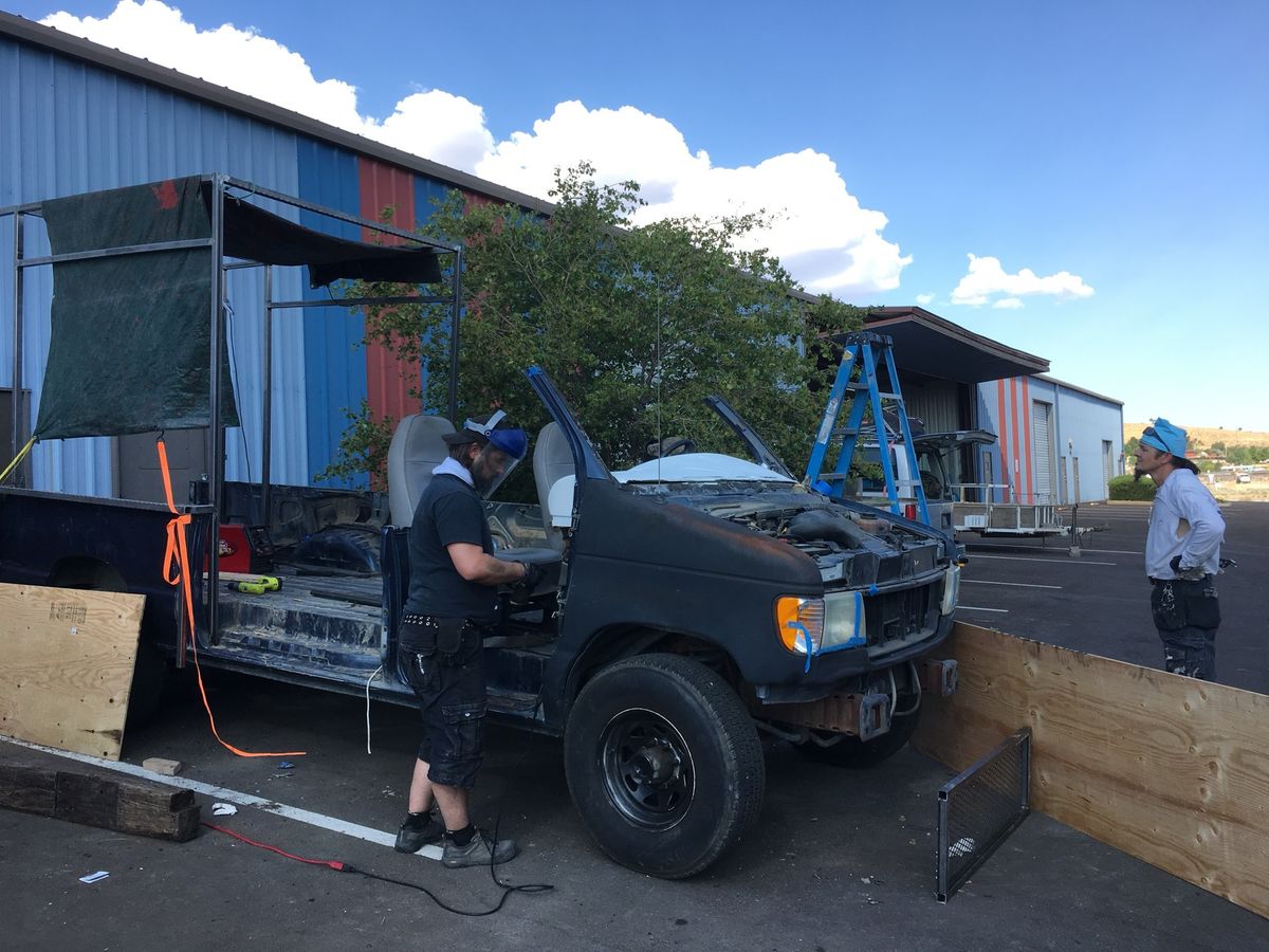 The van with its body cut away behind the front seats and a steel frame going up over the back